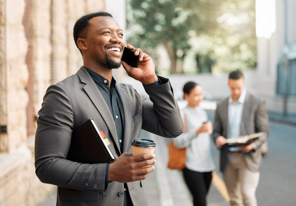 African, businessman and lawyer on coffee break, phone call or conversation for connection in United Kingdom. Worker, smile and mobile as legal expert, employee or professional for law firm in London.