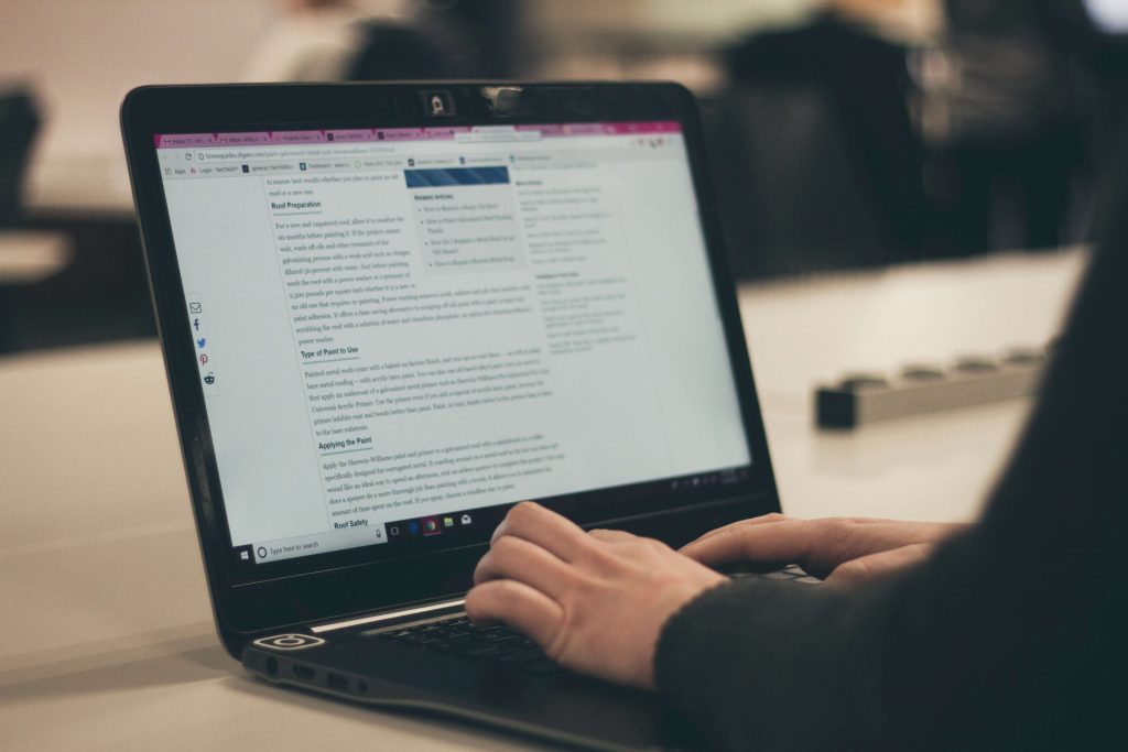 laptop with someone utilising microsoft co pilot for business to do their work.