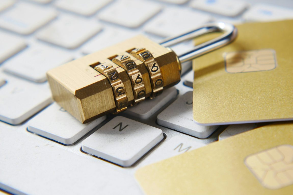 Cyber security image Lock and bank cards resting on a computer